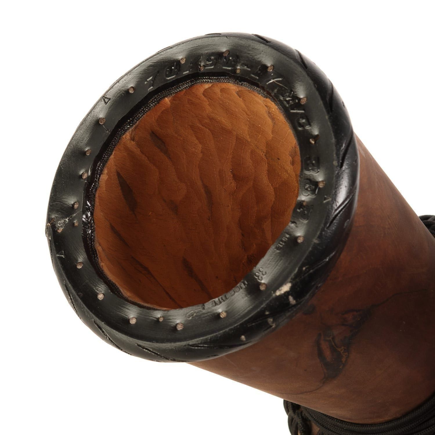 Close-up view of a djembe drum showcasing its hand-carved wooden interior, textured black rim, and traditional craftsmanship details.