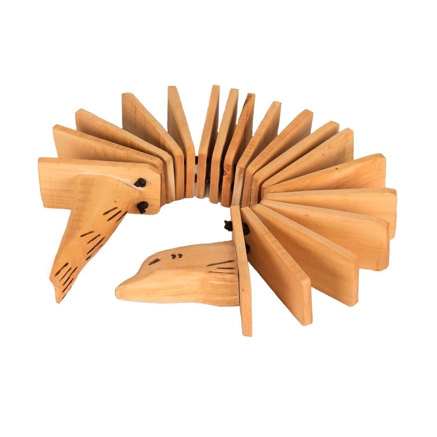 Animal Clacker - Early Years, rolled. It is made of light wood with lots of internal sections. The two handles are the head and tail of an animal.