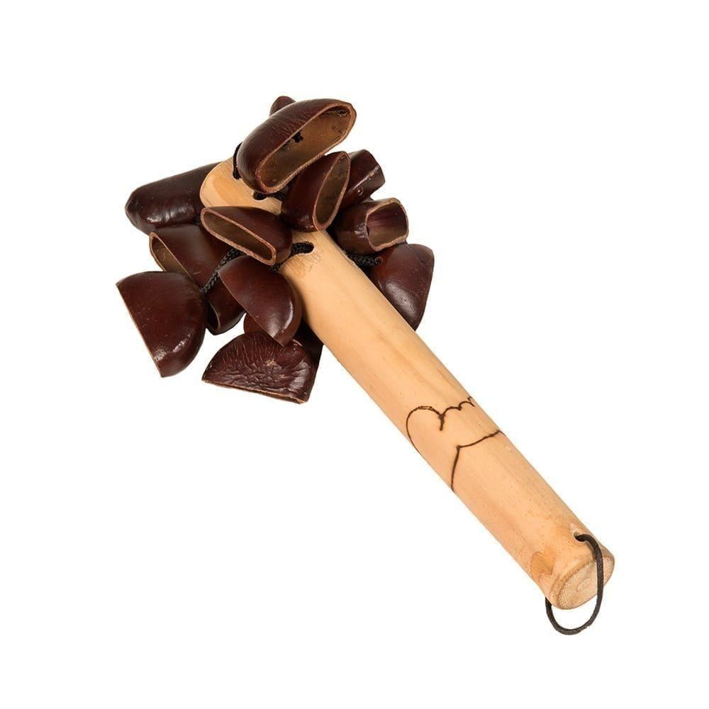 This is a product shot of a Bento Shaker, diagonal shot. It has a wooden or bamboo handle with a design burnt into the wood. At the top are many Bento seeds are attached which make the shaker sound.