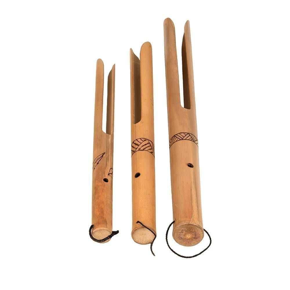 This is a product image of Buzzers - Set of 3, bamboo. Each one is made of a single piece of bamboo. A hole is visible in the neck before it splits into two fingers of wood at the end. There is a line pattern burned in halfway down each neck. The instruments are facing straight upwards and are sized smallest to largest from left to right.