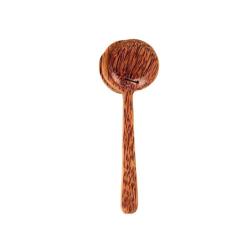 This is a product image of the Castanet-on-Stick. It is made of dark wood and is essentially a pair of Castanets attached to a handle. The instrument is laid out and facing straight upwards.