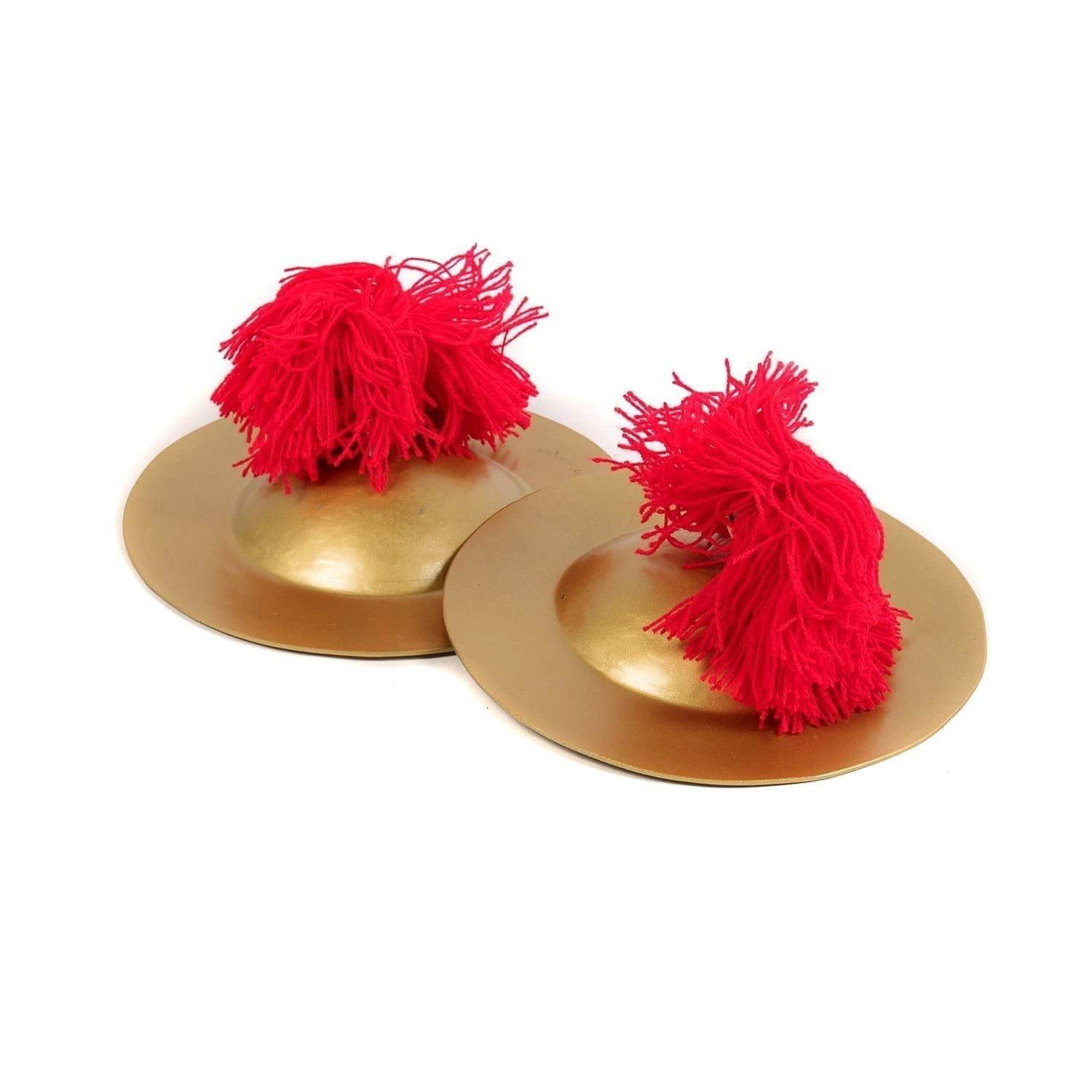 This is a product image of the Ceng Ceng - 18cm, pair. The cymbals are gold coloured with red wool tassled hand holds. The Ceng Ceng are laid out flat, one overlapping the other, with the image taken from the front.