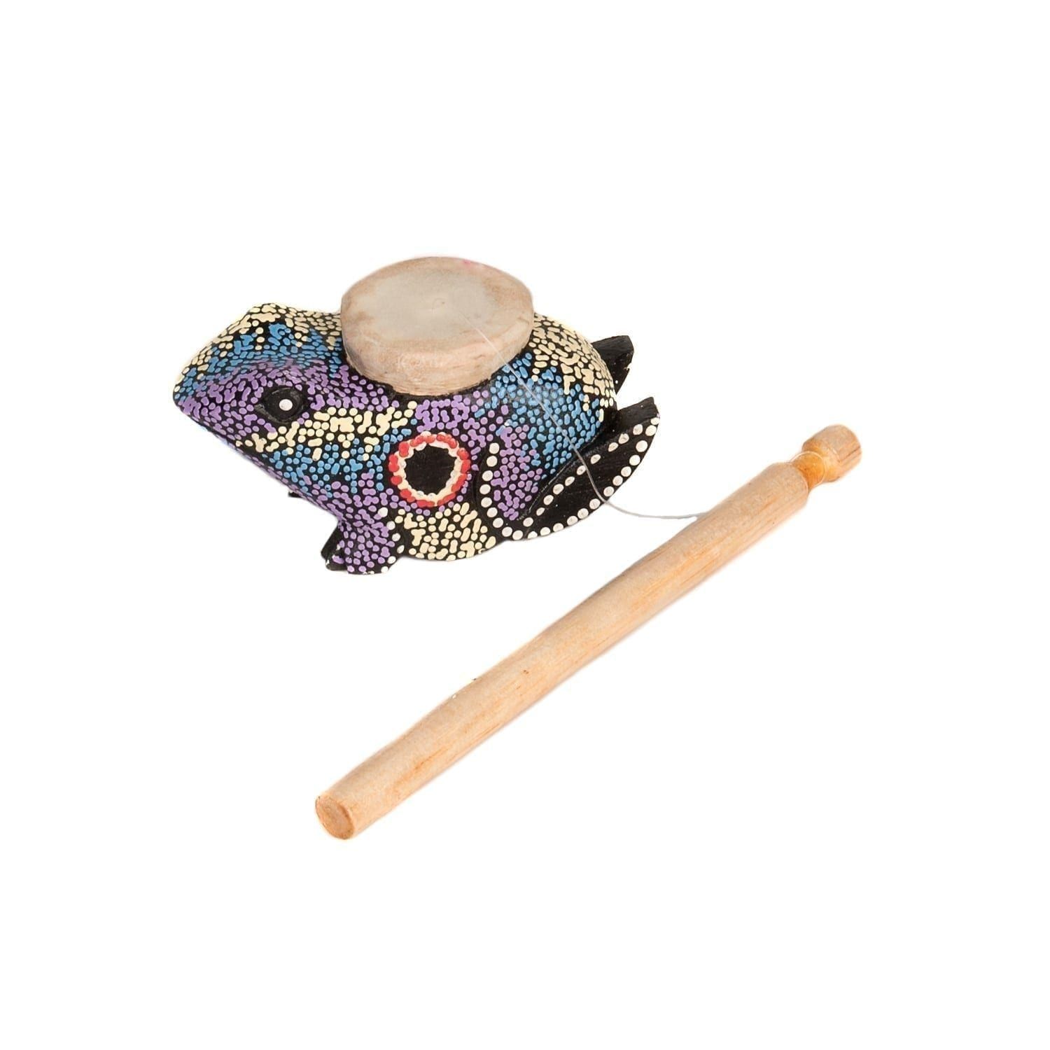This is a product image of the Frog Twirler - painted. A wooden stick is attached to a wire that connects to a frog that has been painted with lots of colored dots, predominately purple. The frog is laid out above the stick.