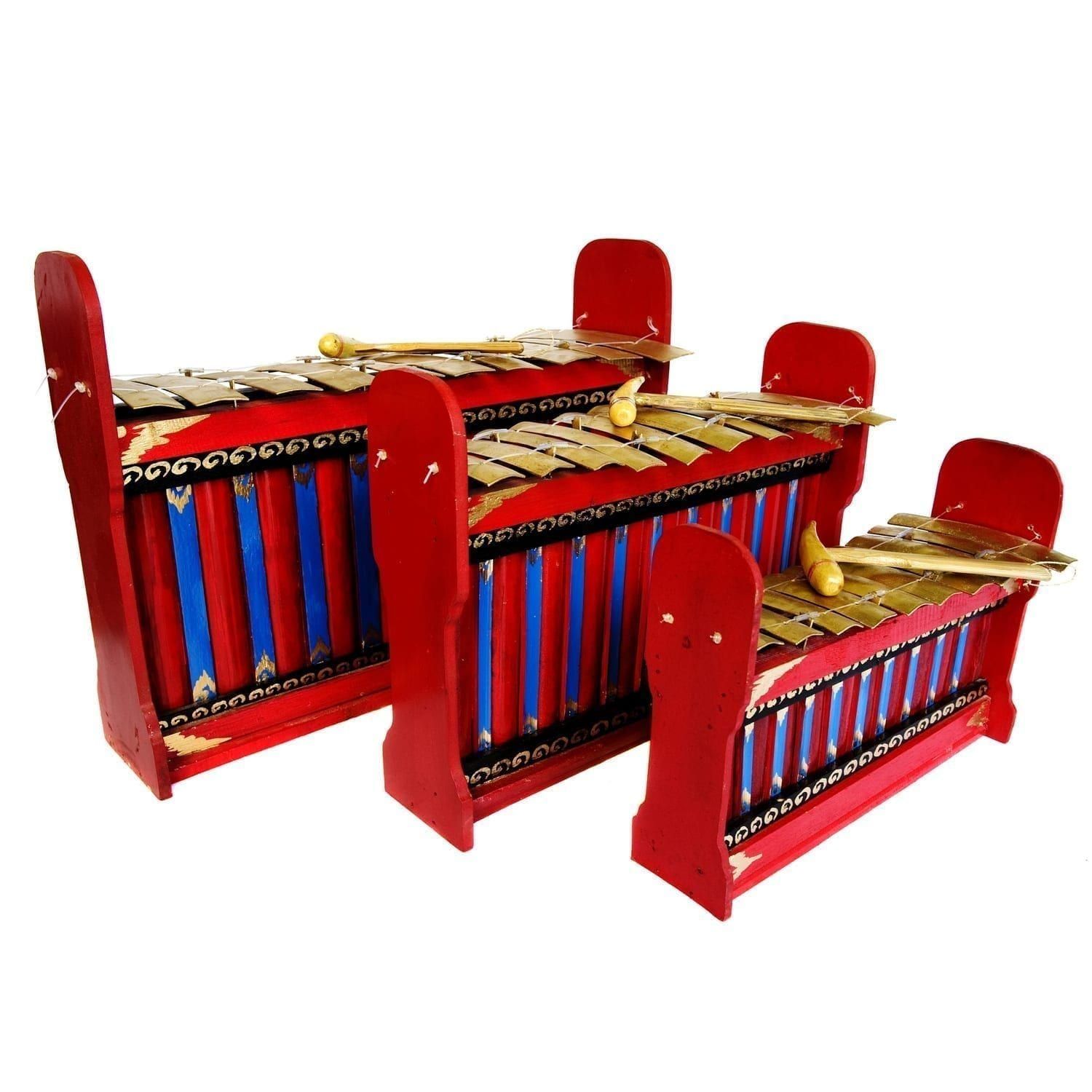 This is a product image of the Gamelan - Budget - 10 key - 3 Pack. It contains three red and blue instruments with gold keys suspended by wire, angled in a row and facing to the right. Each instrument has a beater laying on it. The image shows the Gamelan (Gangsa Ugal) - Budget - Large 10 key, Gamelan (Gangsa Pemad?) - Budget - Medium 10 key and Gamelan (Gangsa Kantilan) - Budget - Small 10 key.