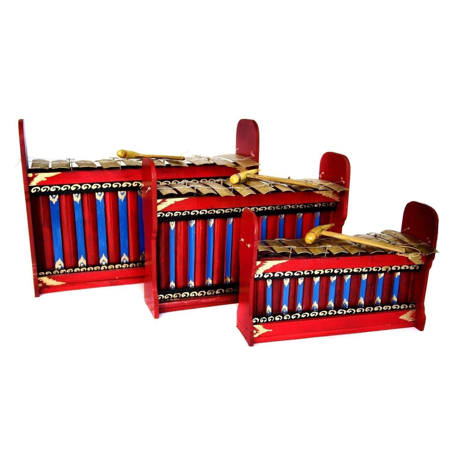 This is a product image of the Gamelan - Budget - 7 key - 3 Pack. It contains three red and blue instruments with gold keys suspended by wire, with the photo taken head on. Each instrument has a beater laying on it. The image shows the Gamelan - Budget - Small 7 key, the Gamelan - Budget - Large 7 key and the Gamelan - Budget - Medium 7 key.