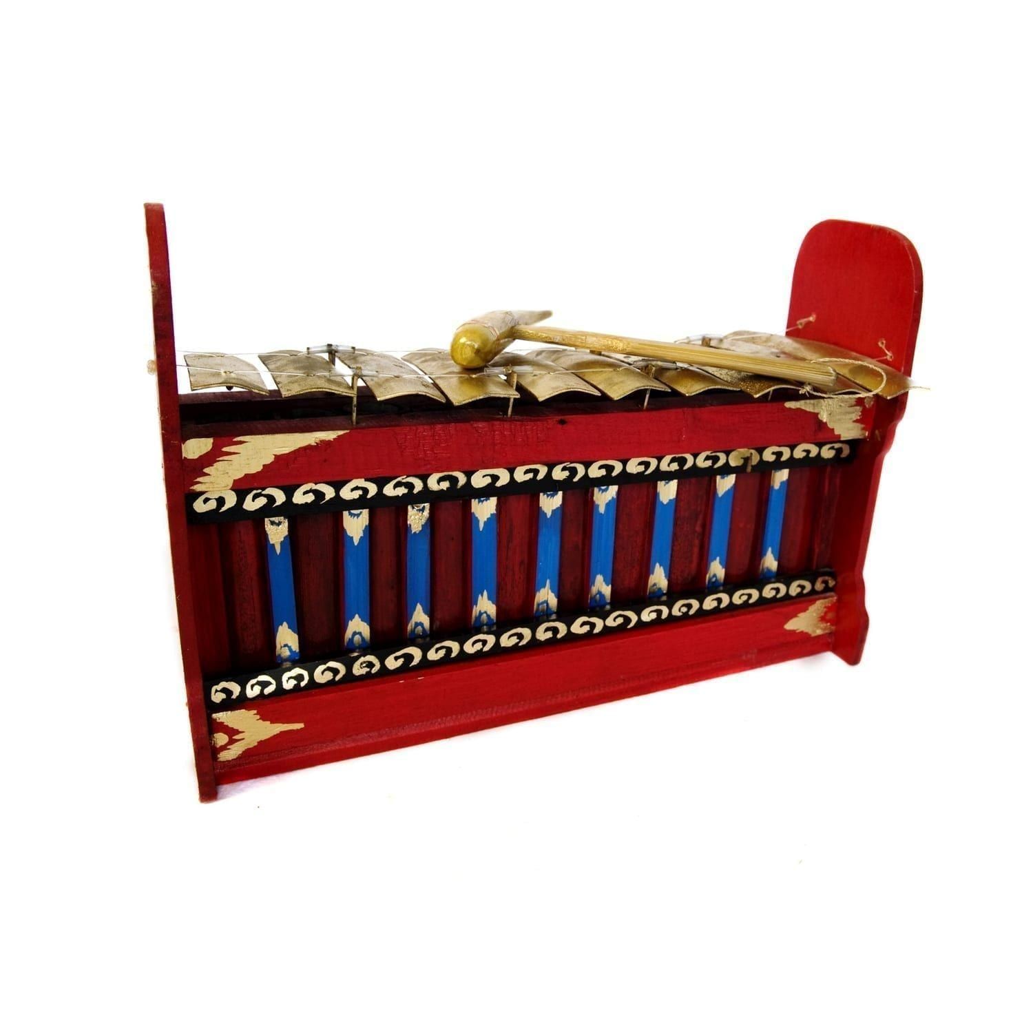 This is a product image of the Gamelan (Gangsa Pemadi) - Budget - Medium 10 key. The image has been taken from the front and the instrument is facing slightly to the right. It is red and blue with gold keys suspended by wire, and the beater is lying on top of the keys.