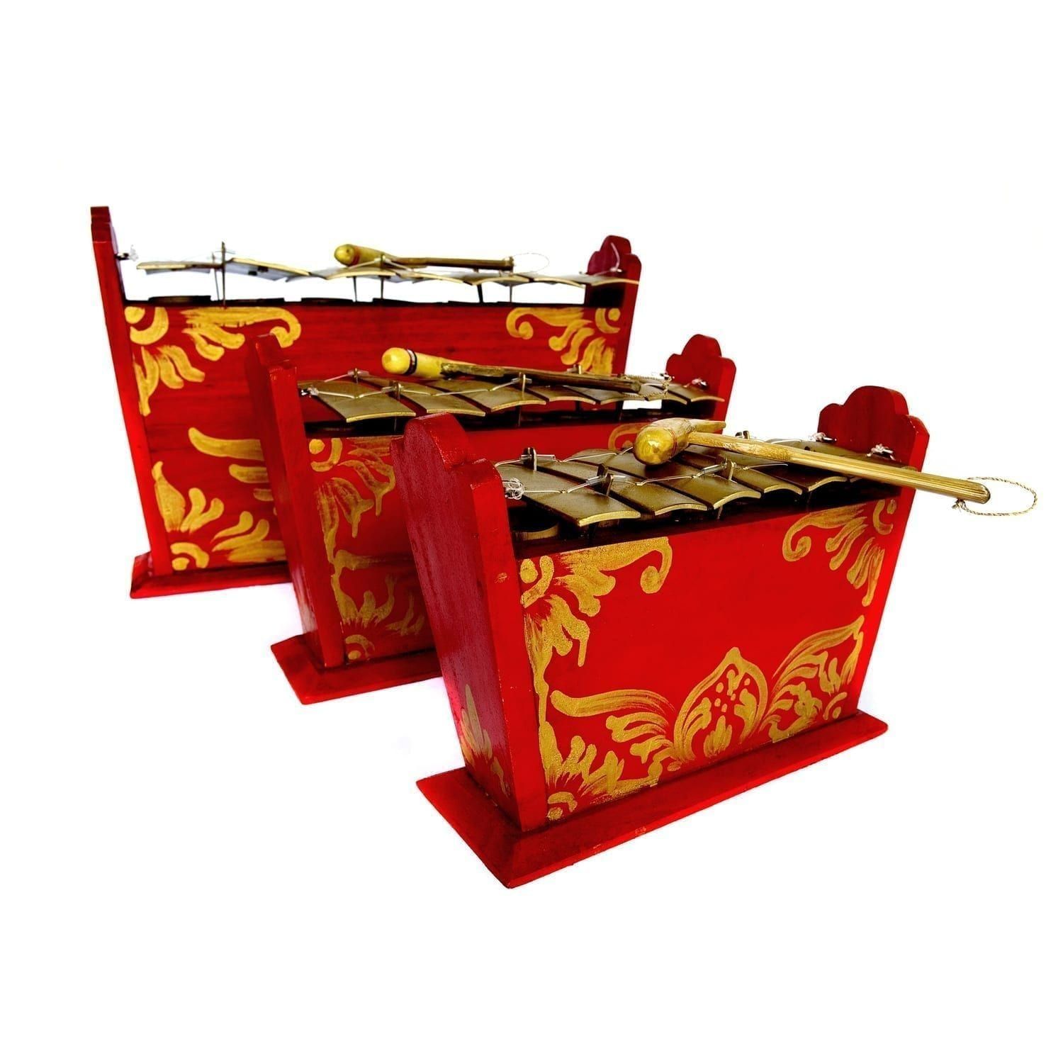 This is a product image of the Gamelan - Standard - 7 key - 3 Pack. The three instruments are red and blue with gold keys suspended from wire and each with a beater resting on the bars. The image shows the instruments in partial profile and closely placed together facing to the right. From left to right the image contains contains the Gamelan - Standard - Large 7 key, Gamelan - Standard - Medium 7 key and Gamelan - Standard - Small 7 key.