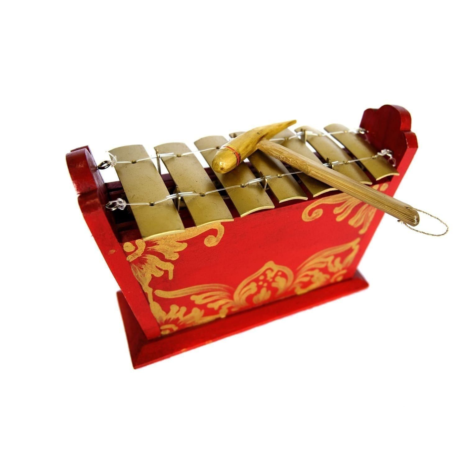 This is a product image of the Gamelan - Standard - Small - 7 key. This is a close up detail shot of the gold keys and the beater which is resting upon the instrument.