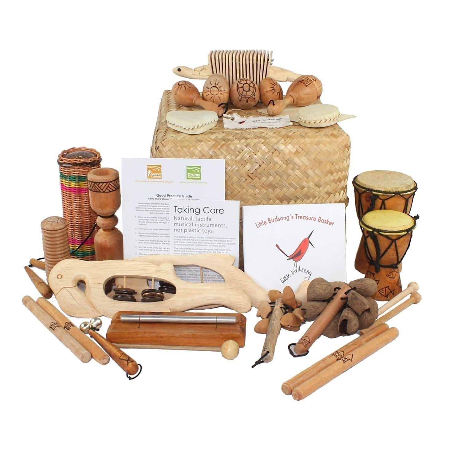This is a product image of the Little Birdsong Treasure Basket - 22 Instruments. All of the varied instruments are placed on or around the Storage Basket, with the CD and cards leaning upright.
