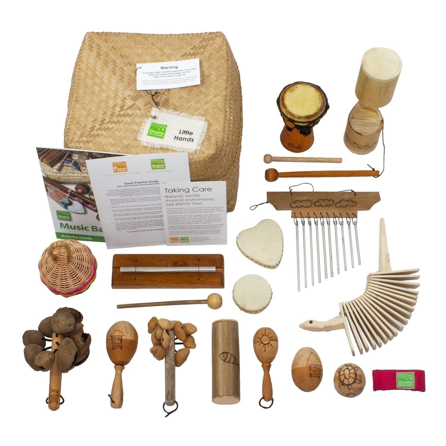 Little Hands Basket - 15 Instruments,All of the varied instruments are placed on or around the Storage Basket, with the guides and cards, all laid out flat outside of the basket.