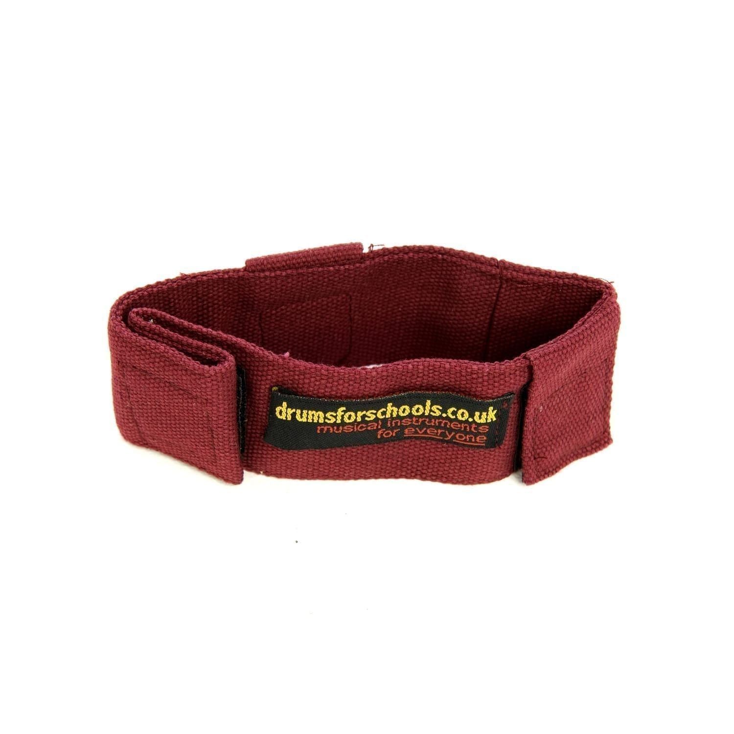 This is a product image of the Music Bracelet - Large. It is red in colour and has a couple of Velcro loops for attaching shakers and other instruments.