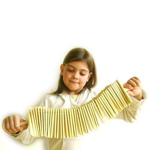 Long Clacker held by a child, pine wood slats stretched in a wide arc for two-handed clacking