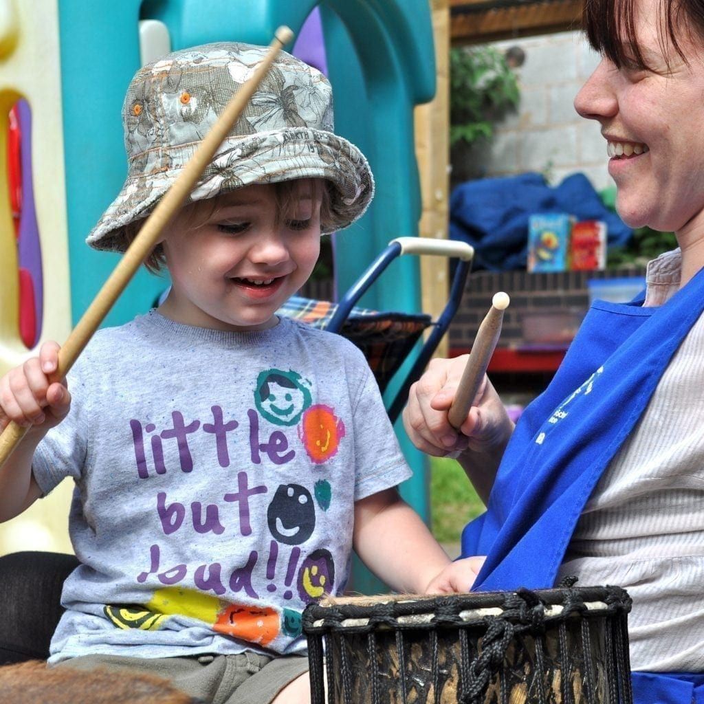 Early Years child playing Drums for Schools' Teeny Weeny Kenkeni Bamboo
