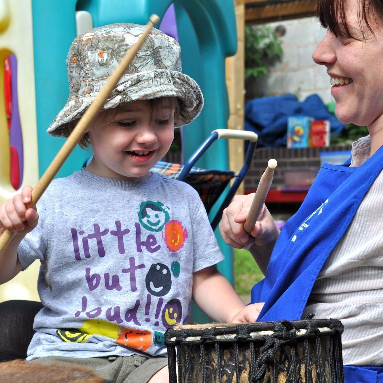 This is an action shot of an Early Years child playing Drums for Schools' Teeny Weeny Kenkeni Bamboo