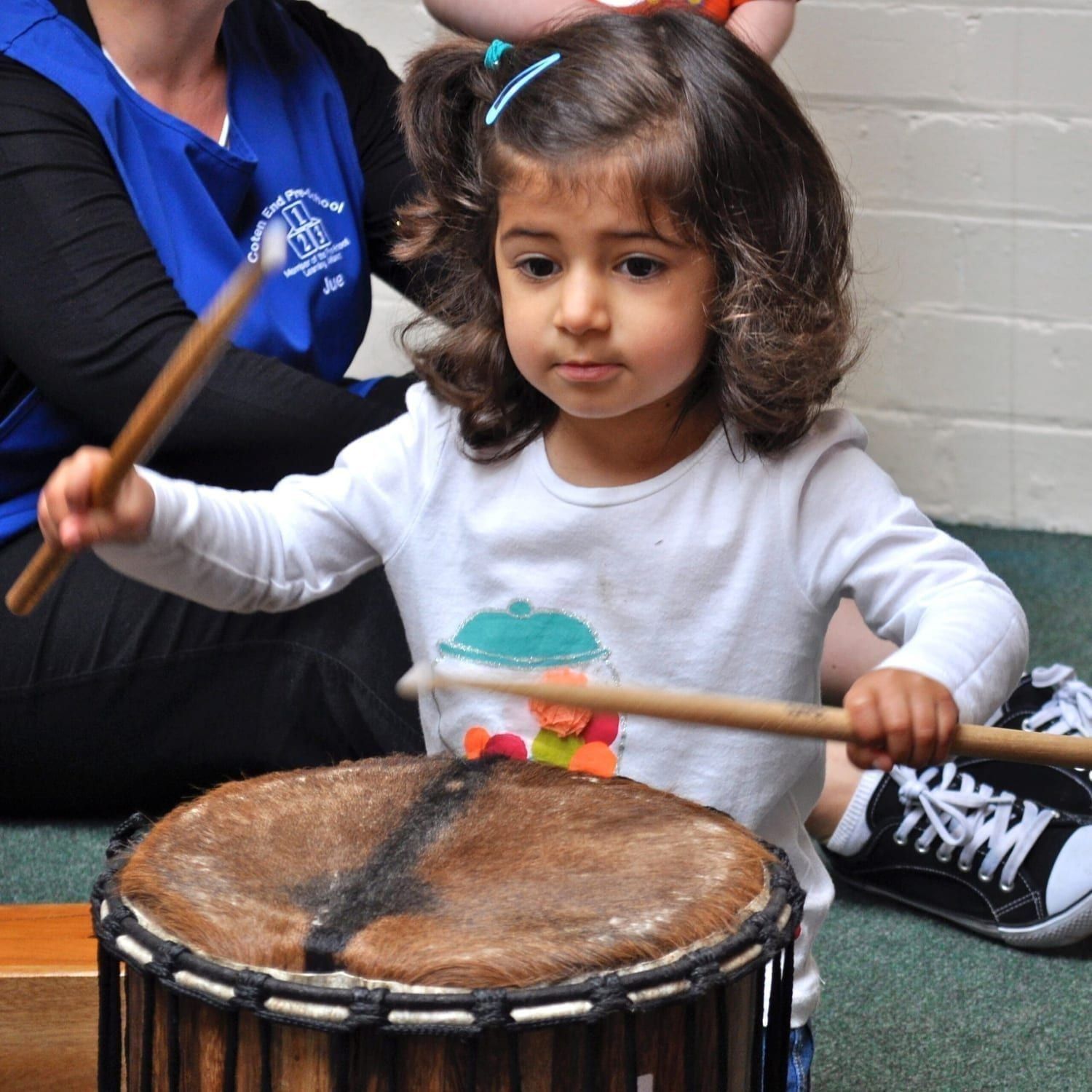 This is an action shot of Early Years children playing Drums for Schools' Mini Kenkeni Bamboo