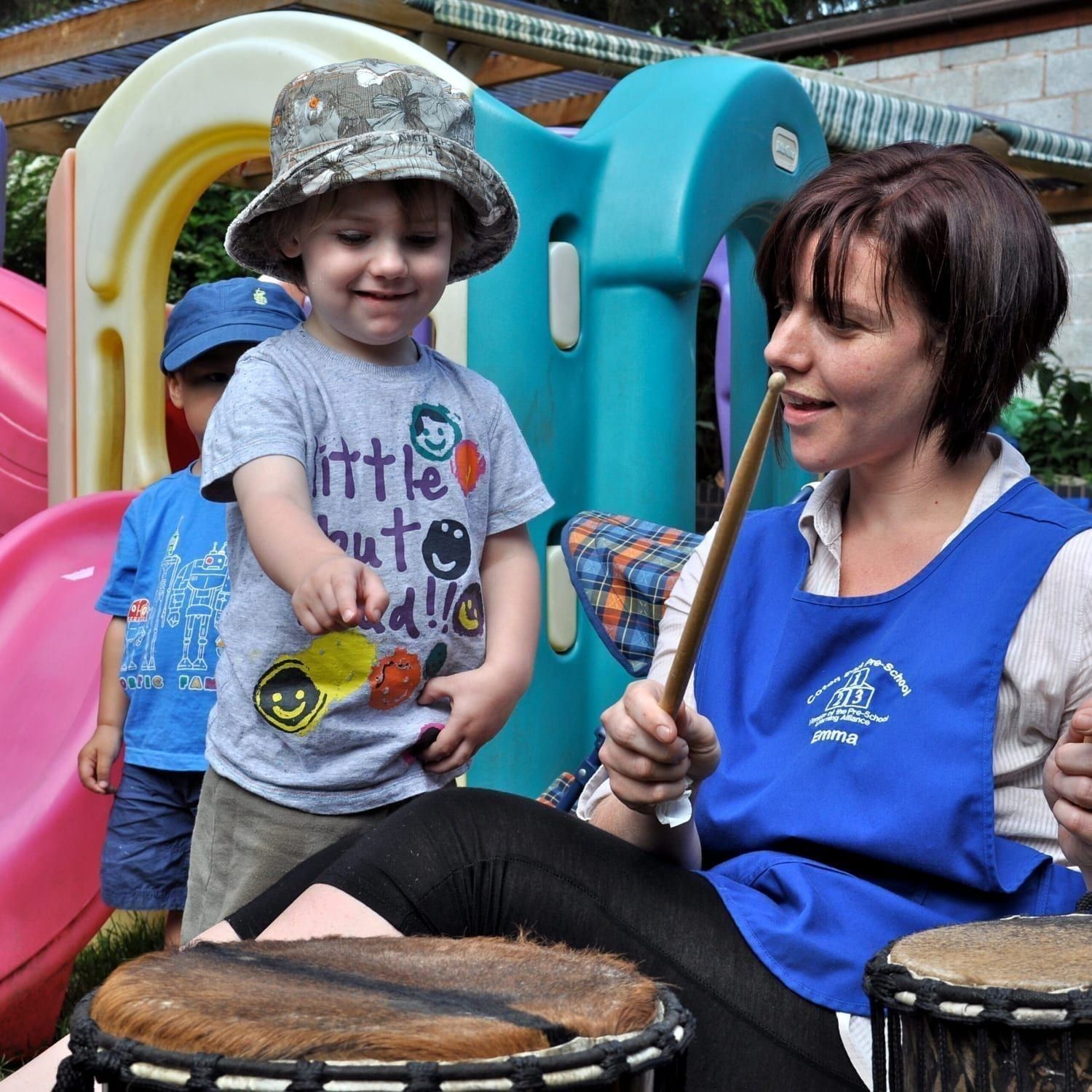 This is an action shot of Early Years children playing Drums for Schools' Mini Kenkeni Bamboo