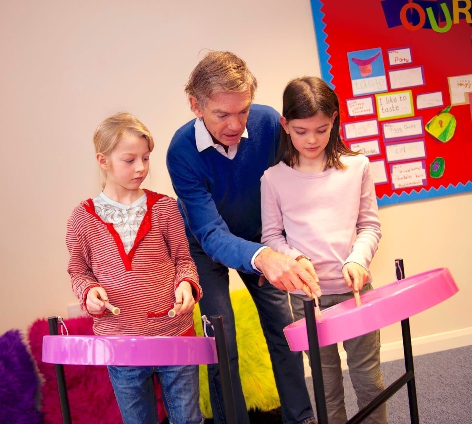 Image showing of Andy Gwatkin showing children how to play Caribbean Steel Pans