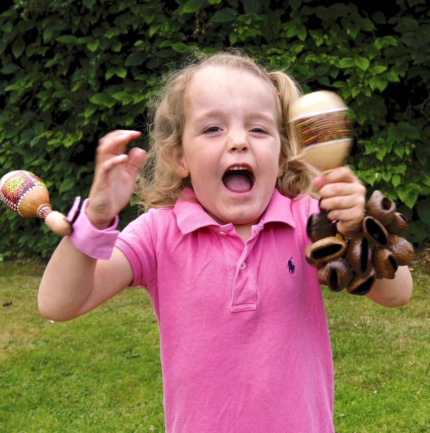 Image of a preschool student playing with Drums for Schools' music bracelet
