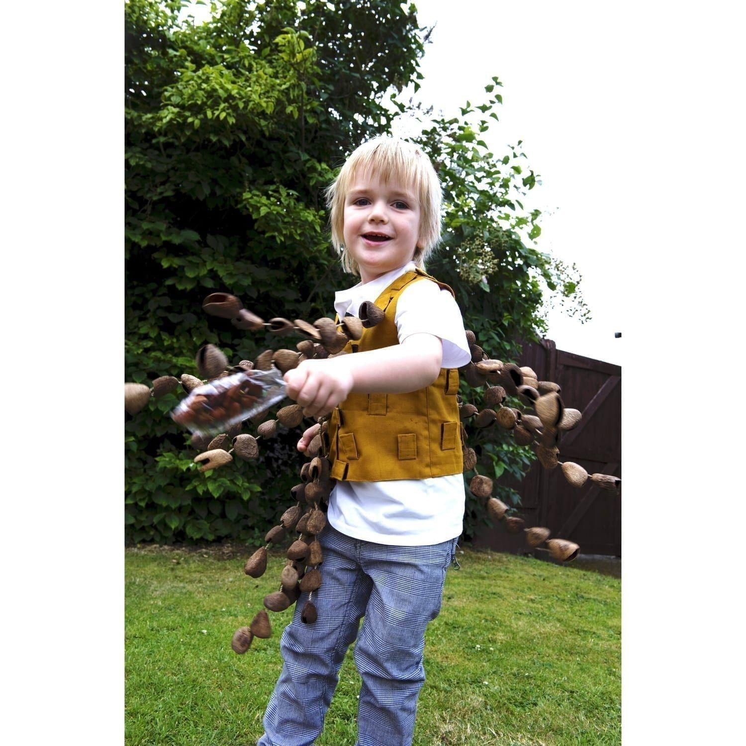 Image of a preschool student playing with Drums for Schools' music tunic