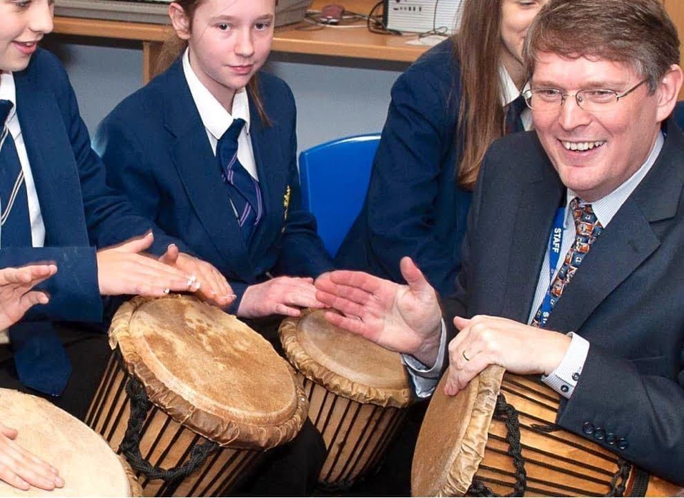 School children playing djembes