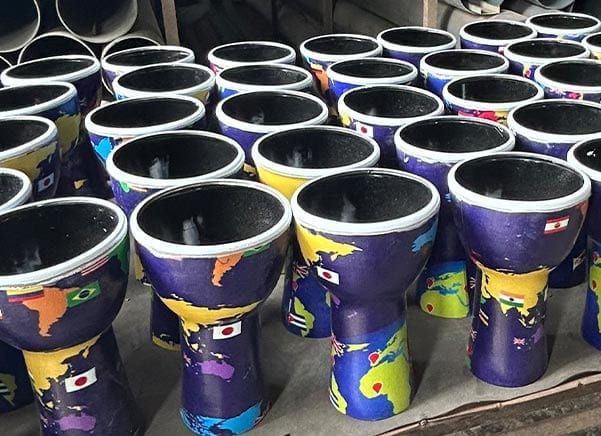 Multiple 7" diameter, 32cm high World Slap synthetic djembe drums, pre-tuned and ready to play.