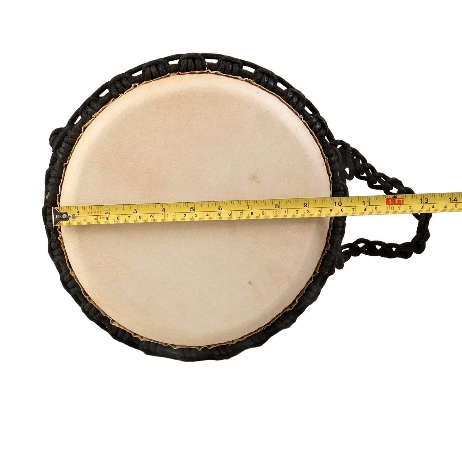 Top-down view of a djembe drum with a goatskin head and black rope tuning. A measuring tape indicates the diameter of the drumhead - Natural Wide Top 10 inch diameter, 50 cm high.