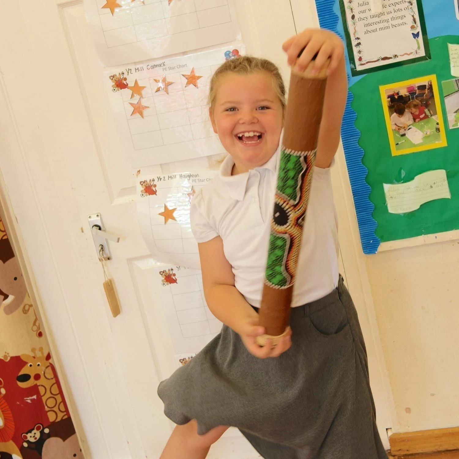 This is a product image of Drums for Schools bamboo rainsticks 80cm, painted, played in action.