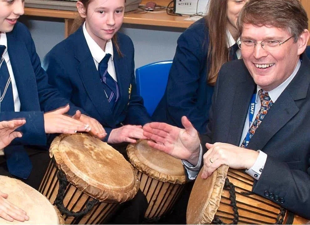 School children playing djembes