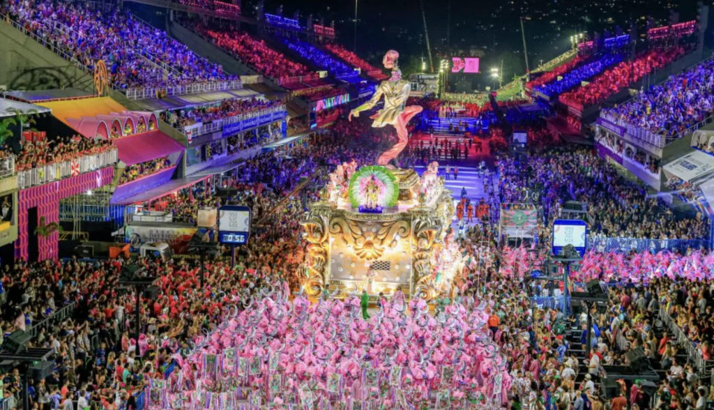 Brazilian Samba Music: Rio Sambadrome parade with giant float and pink-costumed dancers, packed grandstands under lights