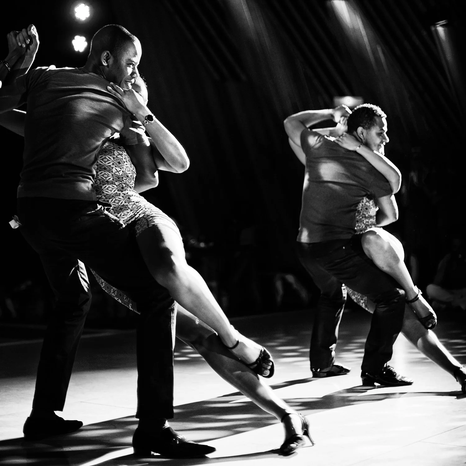 History of Samba Music: Semba dance from Angola with two couples in partnered dip, black-and-white stage lighting