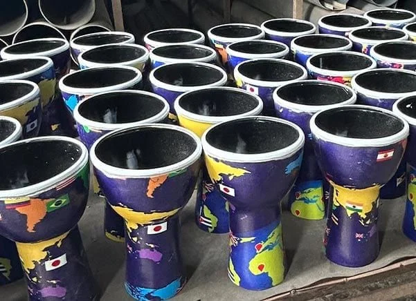 Multiple 7" diameter, 32cm high World Slap synthetic djembe drums, pre-tuned and ready to play.