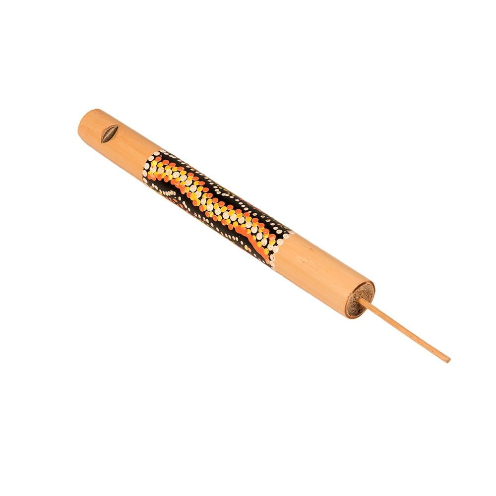 This is a product image of the Swanee Whistle - 20cm, bamboo, painted. It is a bamboo tube that has a mouth piece at one end and a wooden slide inserted into the other. The body of the instrument is decorated in painted dots that form a pattern. The instrument is lying flat and angled from bottom right to top left.